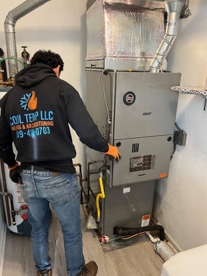 Cool Temp technician servicing a furnace