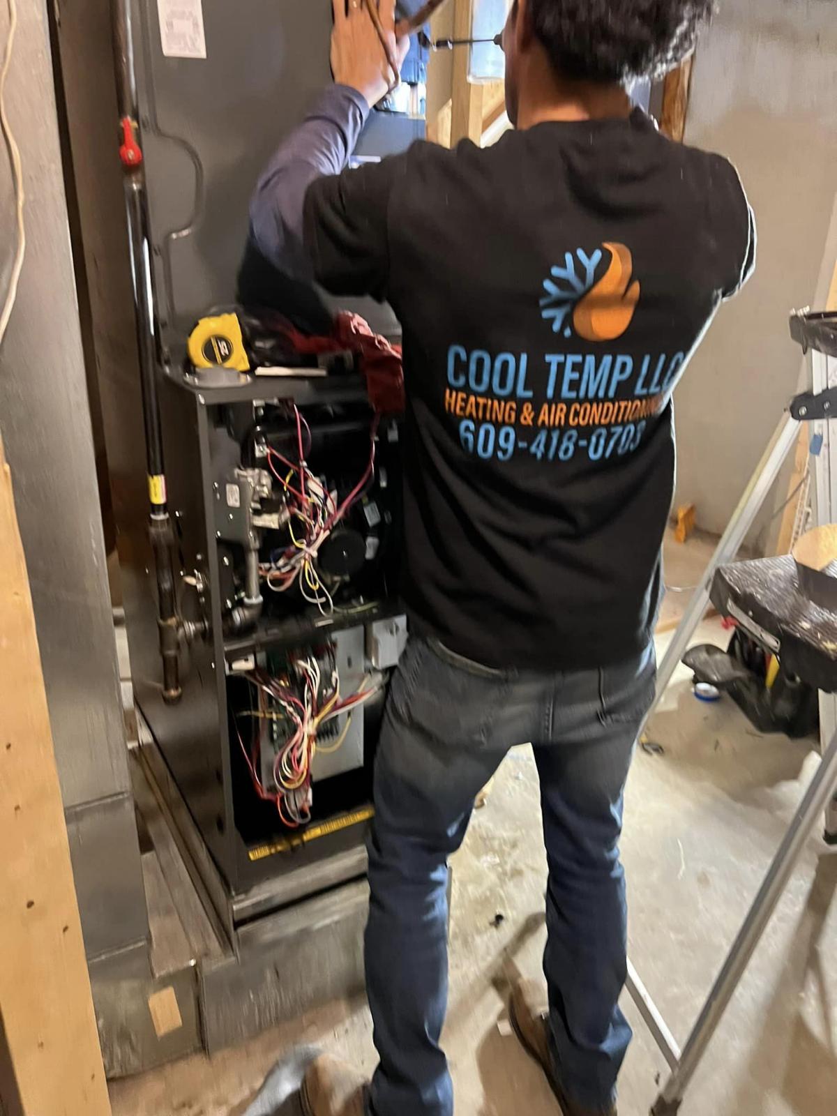 Cool Temp technician working on furnace controls