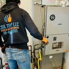 Cool Temp HVAC technician installing a furnace