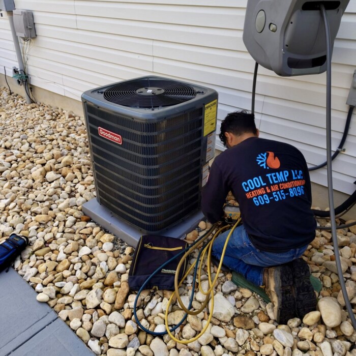 Cool Temp LLC technician installing a new Goodman condenser during an HVAC replacement in New Jersey
